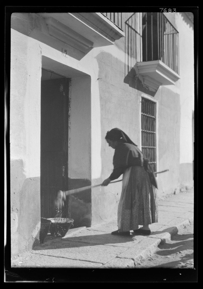 Mujer encalando su casa