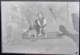 Niño pequeño sujetando a un perro encima de una alfombra, 1931